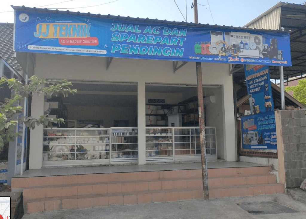 Tampak depan toko JJ Teknik dengan spanduk biru di Jl. Sedap Malam, Pandaan